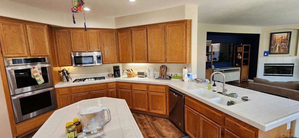 6848 Moorhen Place Carlsbad, CA 92009 - Photo 12 of 53 a kitchen with a sink stove and refrigerator