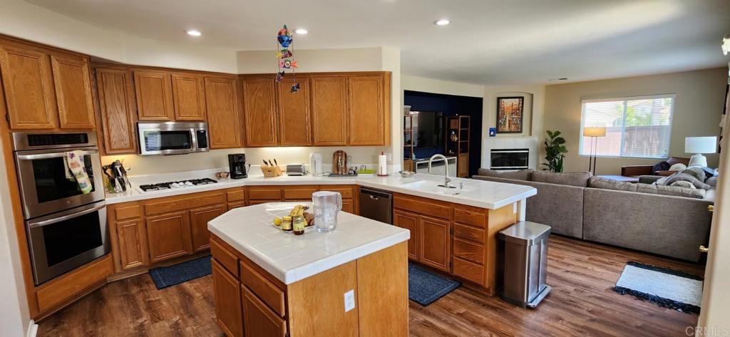 6848 Moorhen Place Carlsbad, CA 92009 - Photo 13 of 53 a kitchen with a sink stove and refrigerator