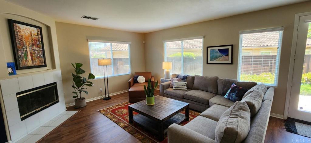 6848 Moorhen Place Carlsbad, CA 92009 - Photo 20 of 53 a living room with furniture a flat screen tv and a fireplace