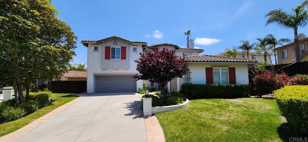 6848 Moorhen Place Carlsbad, CA 92009 - Photo 2 of 53 a front view of a house with a yard and garage