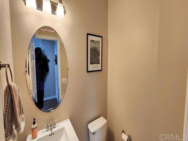 6848 Moorhen Place Carlsbad, CA 92009 - Photo 33 of 53 a bathroom with a toilet and a mirror