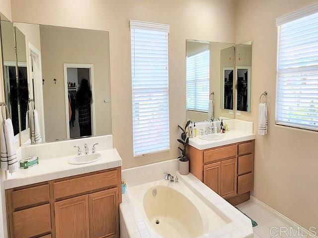 6848 Moorhen Place Carlsbad, CA 92009 - Photo 42 of 53 a bathroom with a sink double vanity and a mirror