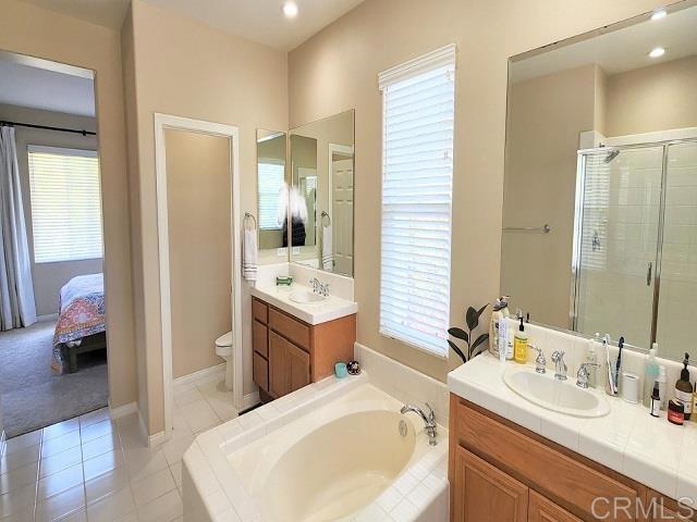 6848 Moorhen Place Carlsbad, CA 92009 - Photo 43 of 53 a en suite bathroom with a double vanity sink and a mirror
