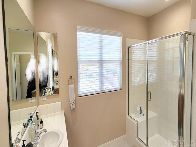 6848 Moorhen Place Carlsbad, CA 92009 - Photo 44 of 53 a bathroom with a sink and a mirror