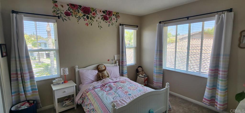 6848 Moorhen Place Carlsbad, CA 92009 - Photo 45 of 53 a bedroom with a bed and a window