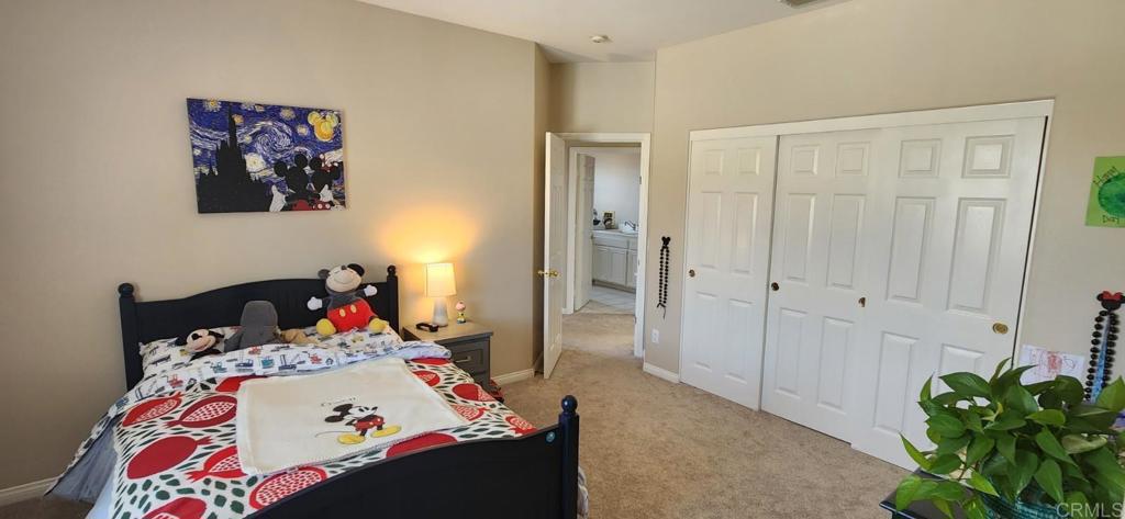 6848 Moorhen Place Carlsbad, CA 92009 - Photo 47 of 53 a bedroom with a bed and a potted plant