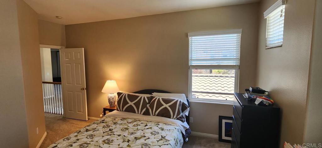 6848 Moorhen Place Carlsbad, CA 92009 - Photo 50 of 53 a bedroom with a bed and a window