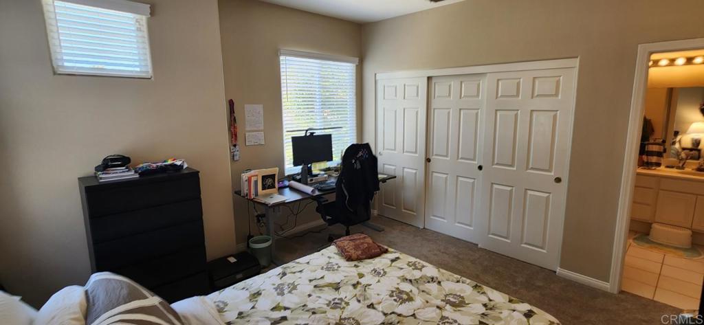 6848 Moorhen Place Carlsbad, CA 92009 - Photo 51 of 53 a bedroom with a bed and wooden floor