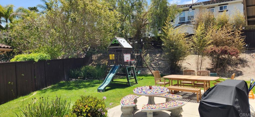 6848 Moorhen Place Carlsbad, CA 92009 - Photo 9 of 53 a view of backyard of house along with seating space