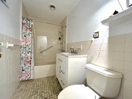 a bathroom with a toilet and shower