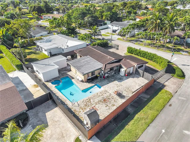 an aerial view of a house with a big yard