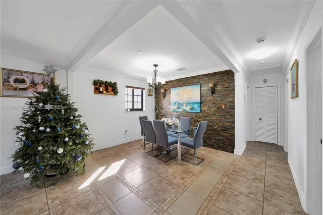 a view of a dining room with furniture and chandelier