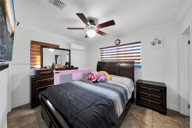 a bedroom with a bed and flat screen tv