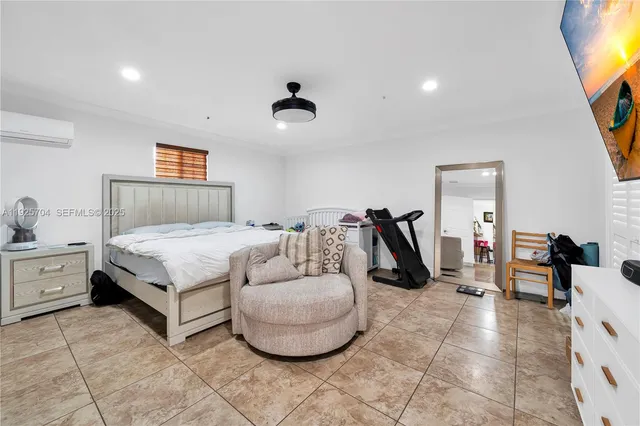 a bedroom with bed and a chandelier