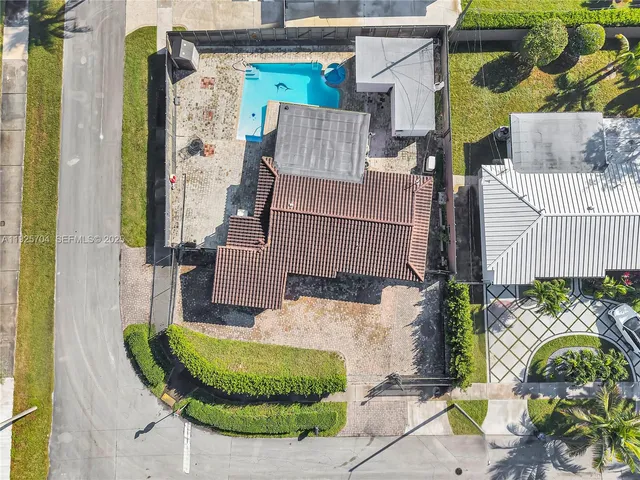 an aerial view of a house with a garden and swimming pool
