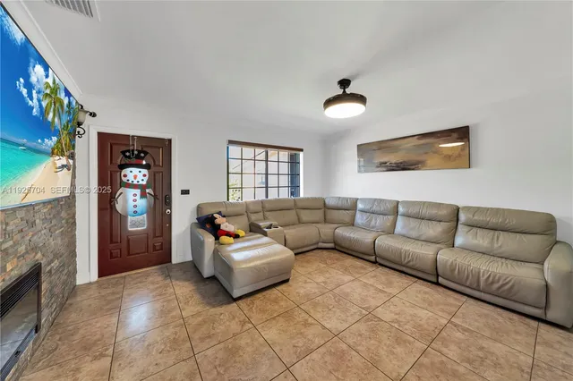 a kitchen with granite countertop a refrigerator sink and wooden cabinets