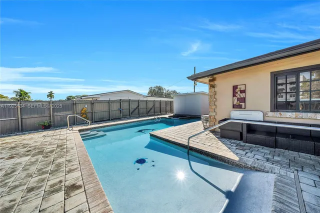 a swimming pool with outdoor seating