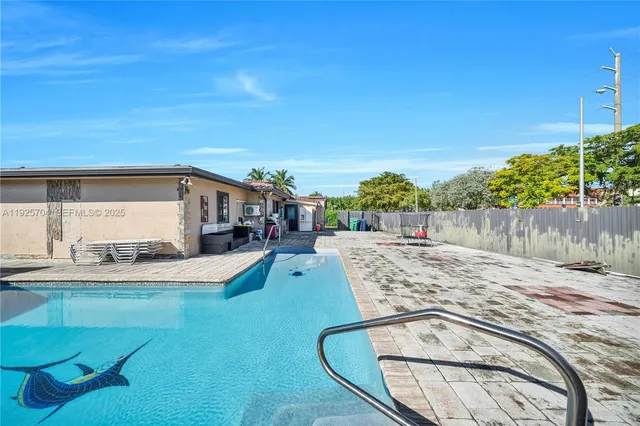 a view of a swimming pool with an outdoor seating