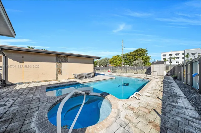 a view of a backyard with a small cabin and a chair