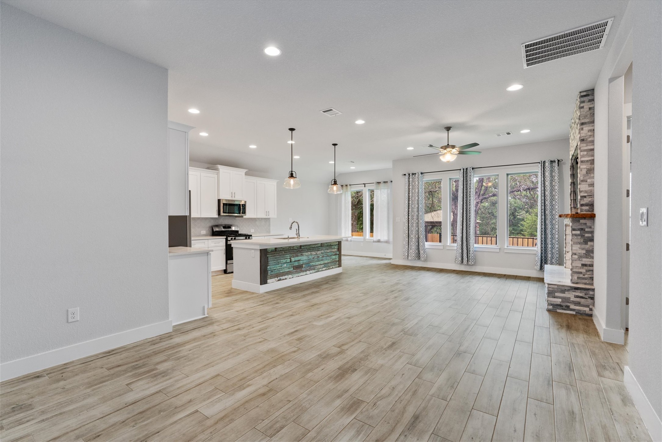 941 Del Raphael Drive Leander, TX 78641 - Photo 3 of 31 Wood-look tile floors are a total game changer for high traffic, running seamlessly through the common areas