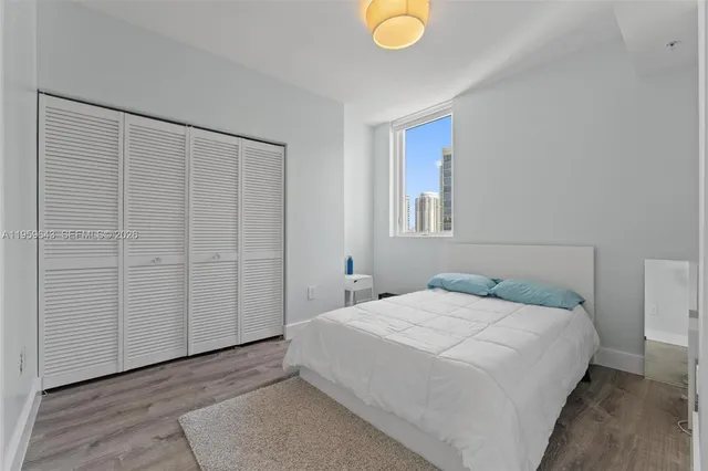 a bedroom with a bed and cabinets