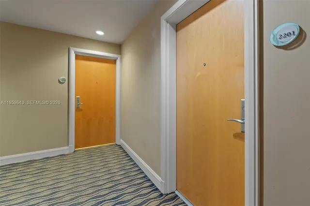 a kitchen that has a lot of cabinets a sink and appliances in it