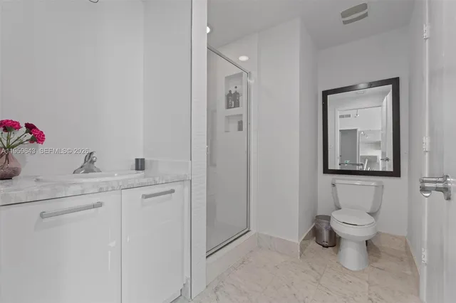 a bathroom with a toilet a sink and shower