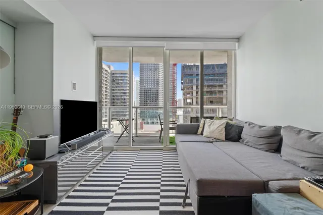 a bedroom with a large bed and a large window