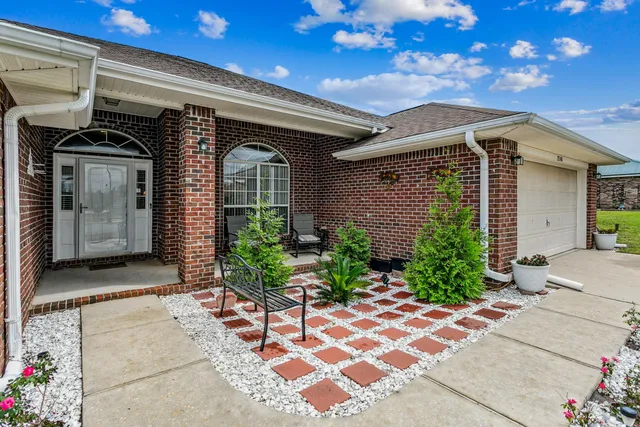 a front view of a house with garden