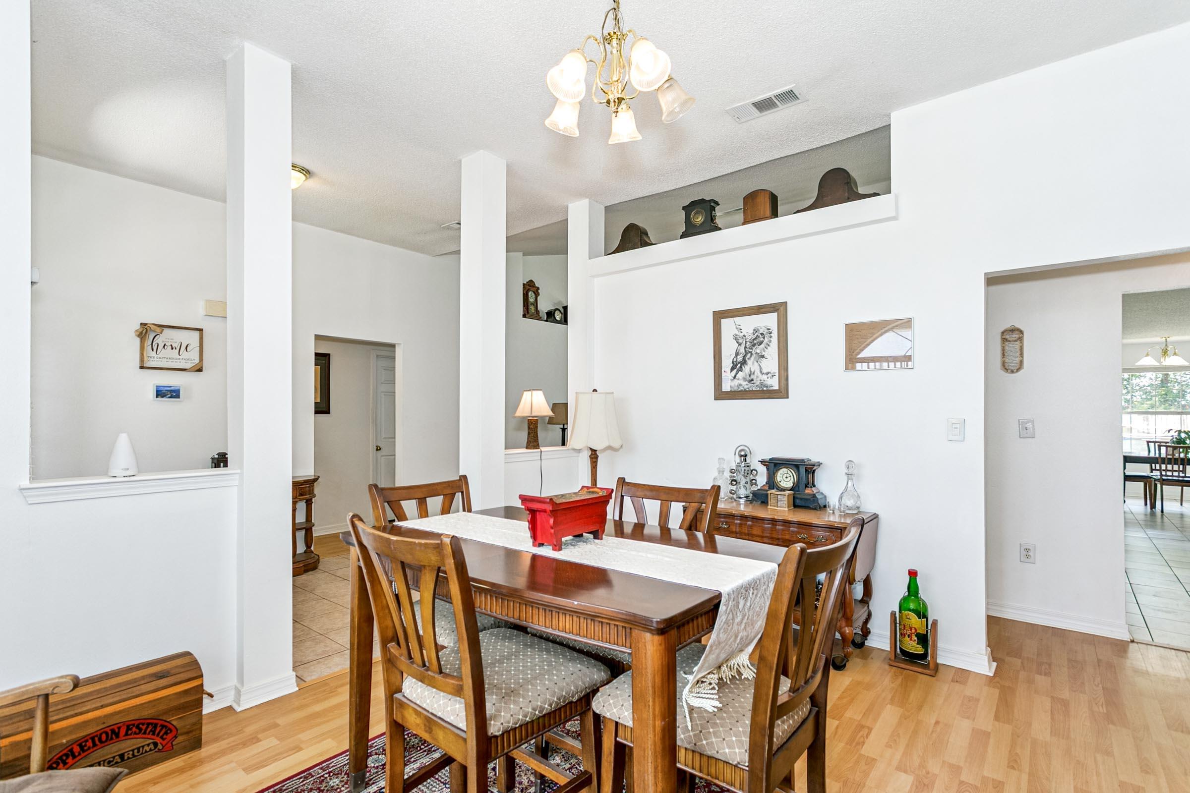 2246 Titanium Drive Crestview, FL 32536 - Photo 11 of 38 a view of a dining room with furniture and wooden floor