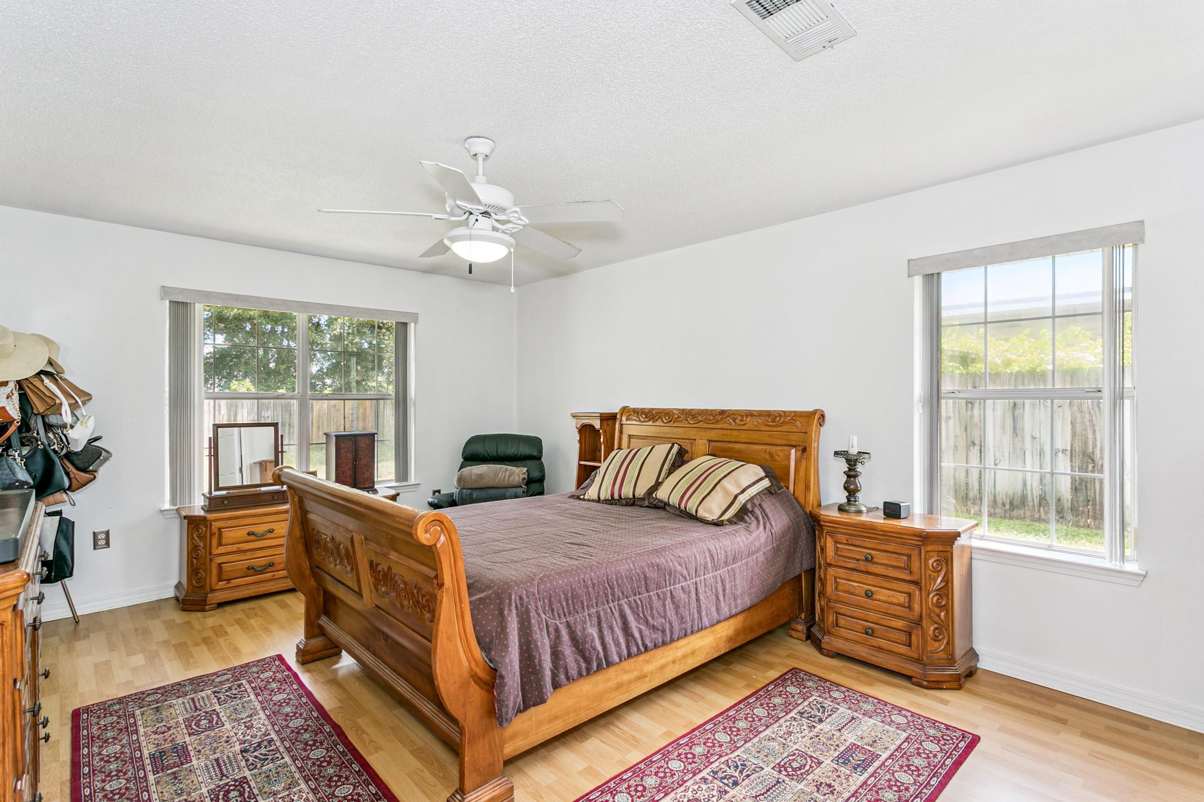 2246 Titanium Drive Crestview, FL 32536 - Photo 12 of 38 a bedroom with a large bed and a window