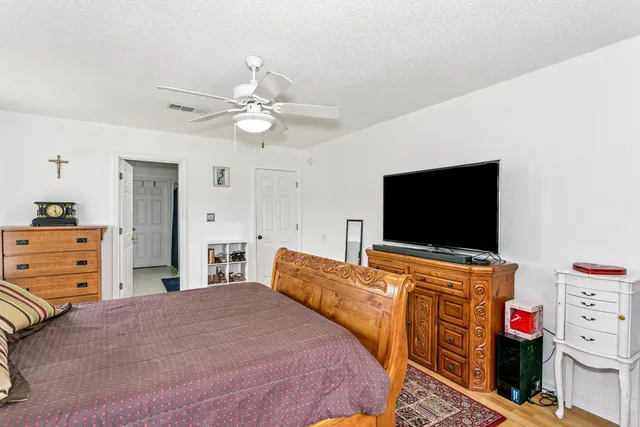 a bedroom with furniture and a flat screen tv