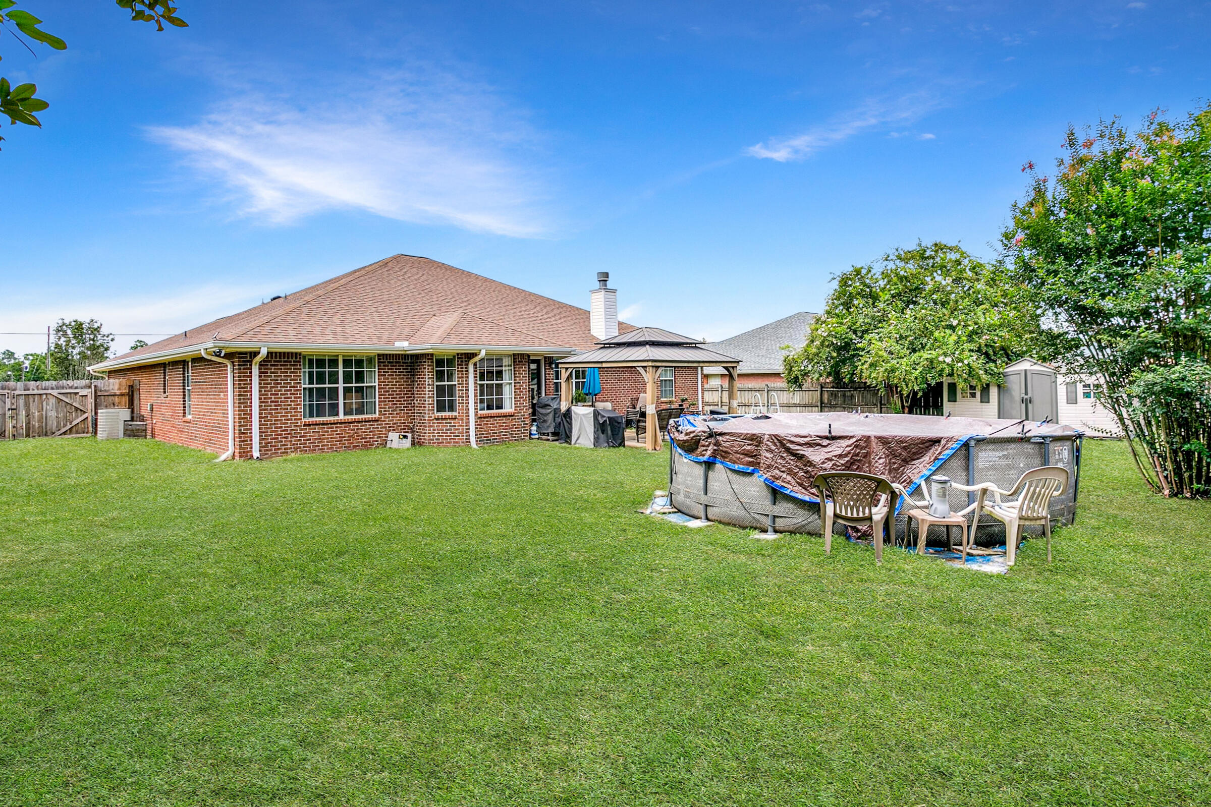 2246 Titanium Drive Crestview, FL 32536 - Photo 22 of 38 a view of a house with backyard porch and sitting area