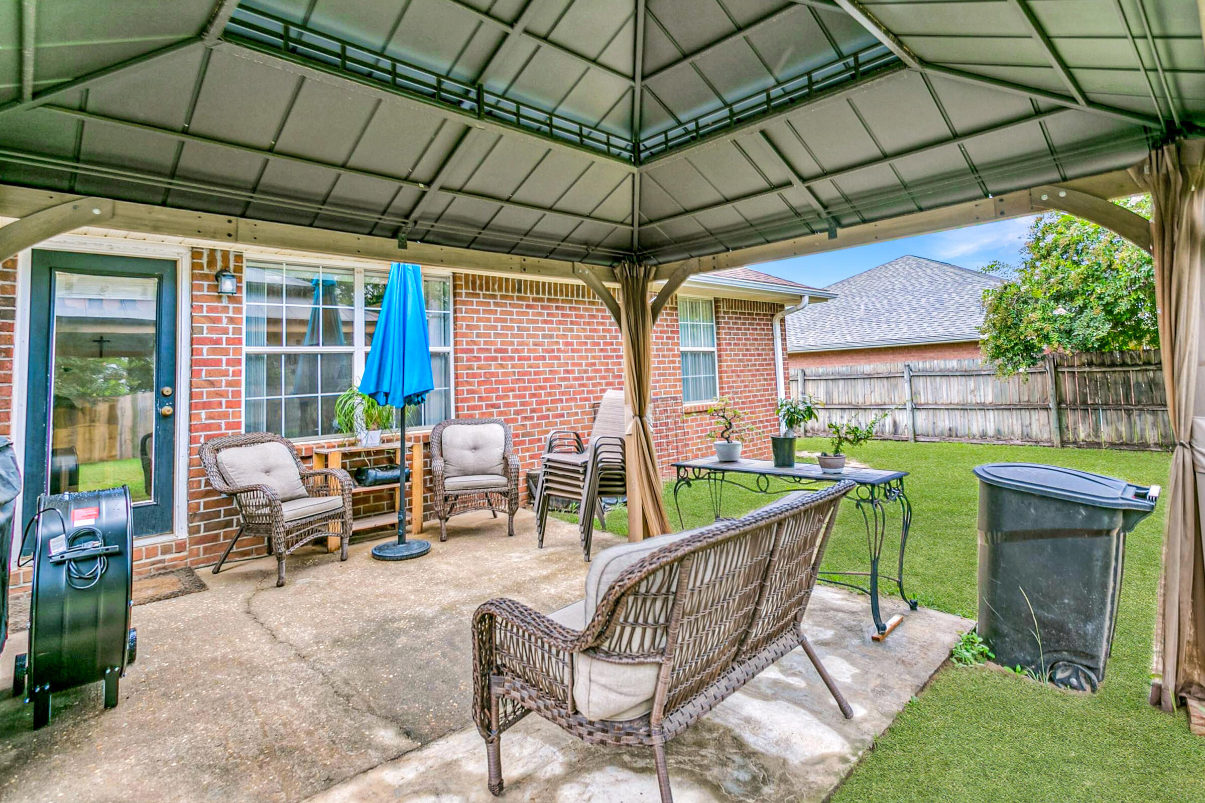 2246 Titanium Drive Crestview, FL 32536 - Photo 28 of 38 a patio with a table and chairs