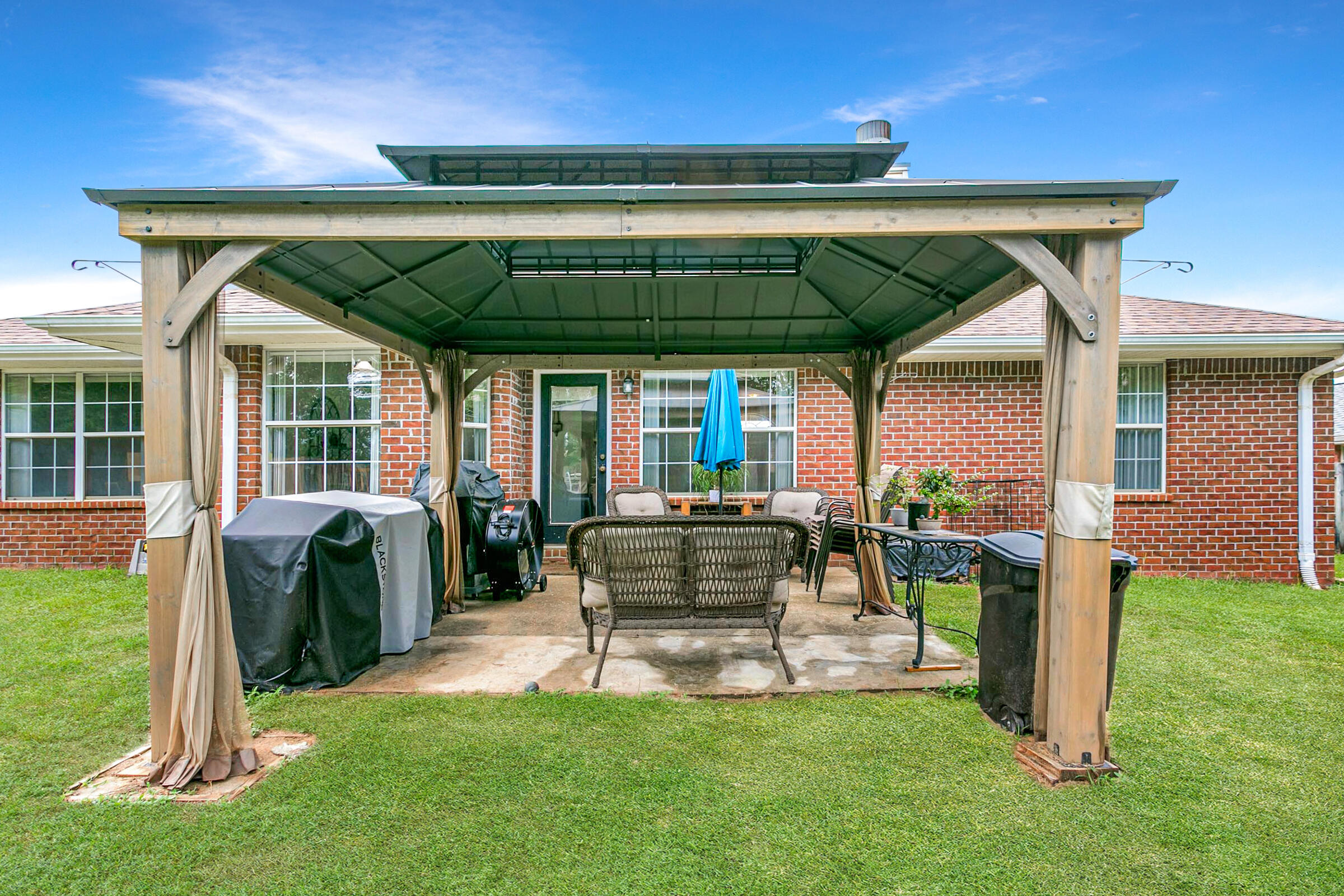 2246 Titanium Drive Crestview, FL 32536 - Photo 29 of 38 a view of a house with backyard sitting area and garden