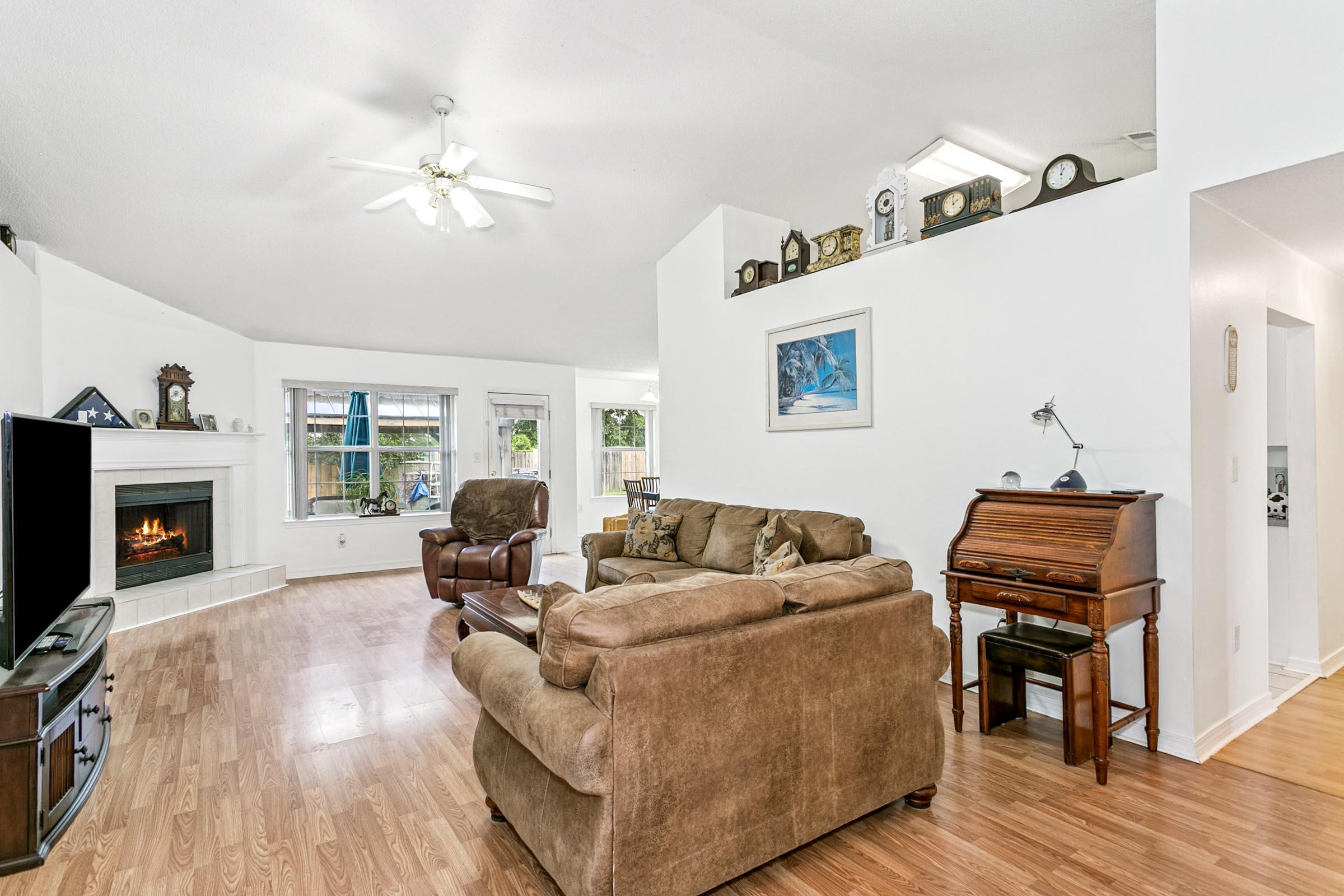 2246 Titanium Drive Crestview, FL 32536 - Photo 3 of 38 a living room with furniture and a fireplace
