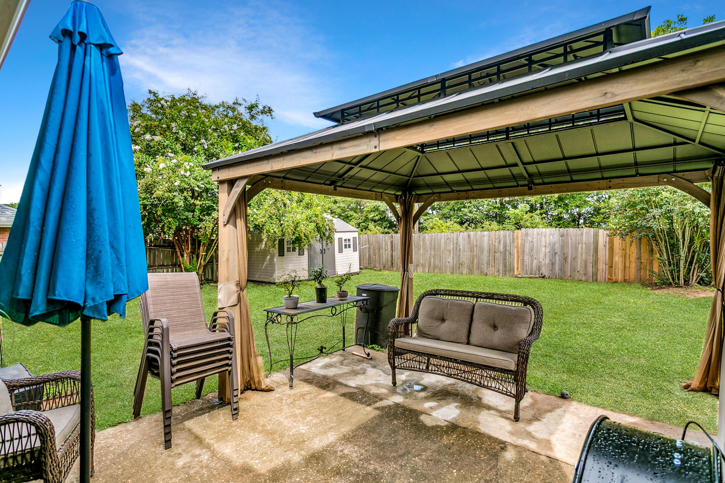 2246 Titanium Drive Crestview, FL 32536 - Photo 30 of 38 a view of backyard with outdoor seating and green space