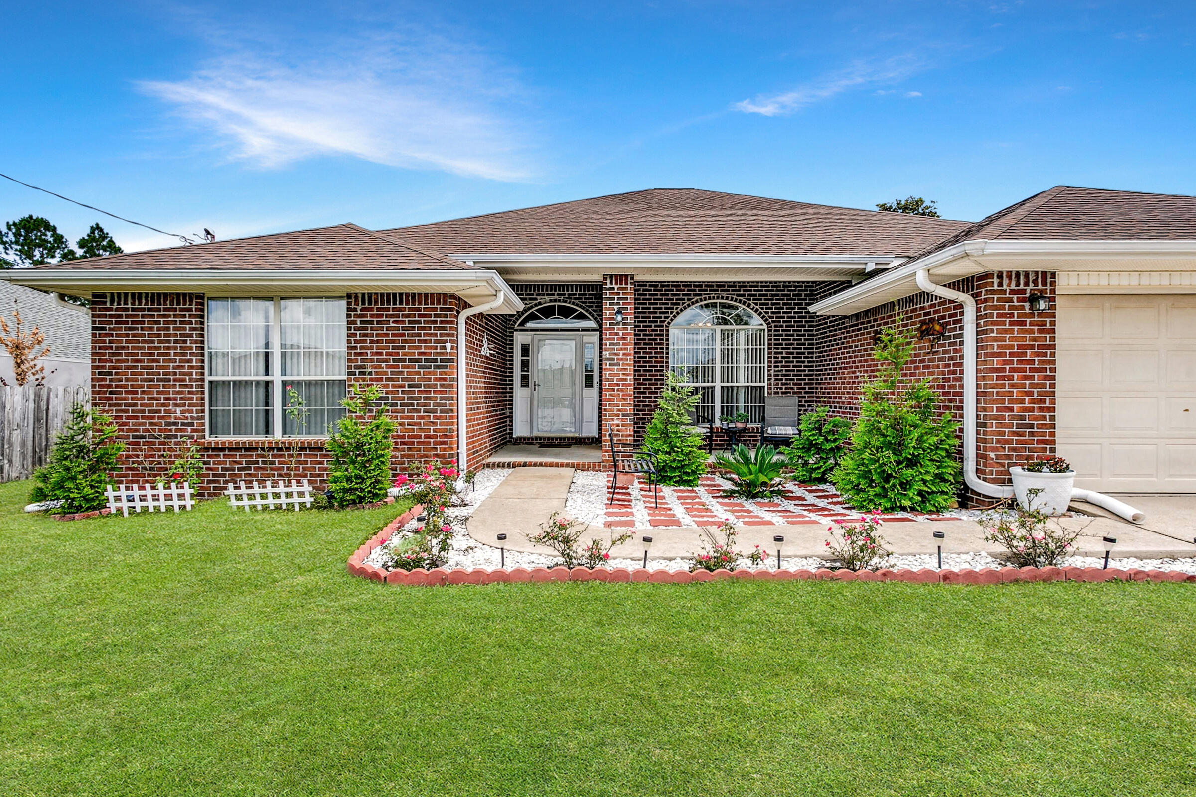 2246 Titanium Drive Crestview, FL 32536 - Photo 31 of 38 a front view of a house with a garden