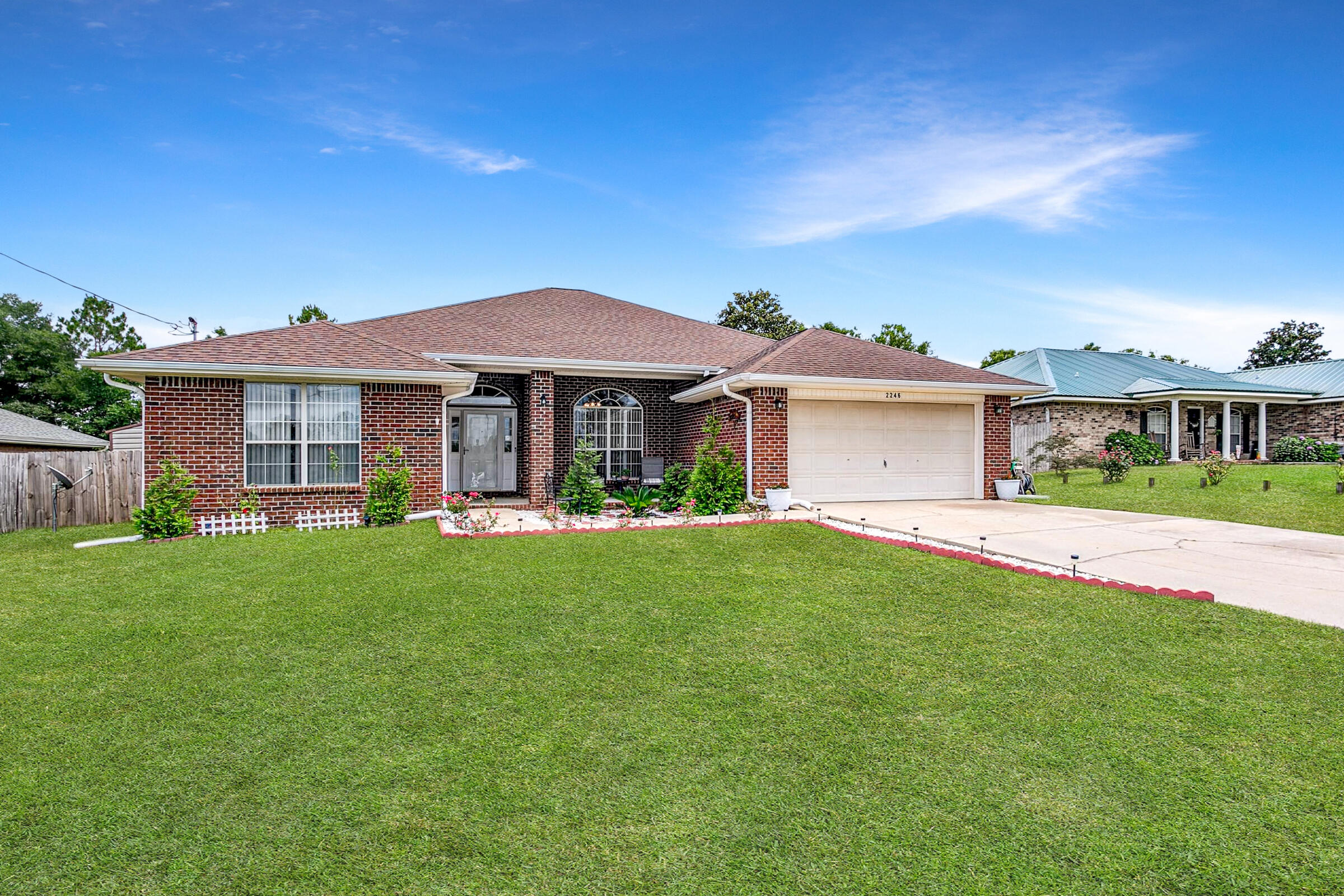2246 Titanium Drive Crestview, FL 32536 - Photo 32 of 38 a front view of a house with a garden