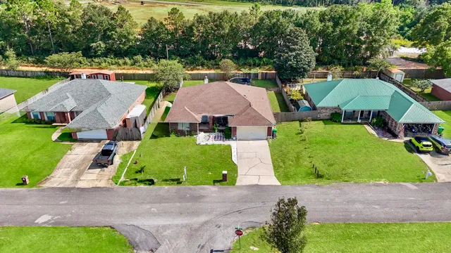 a front view of a house with a garden and plants
