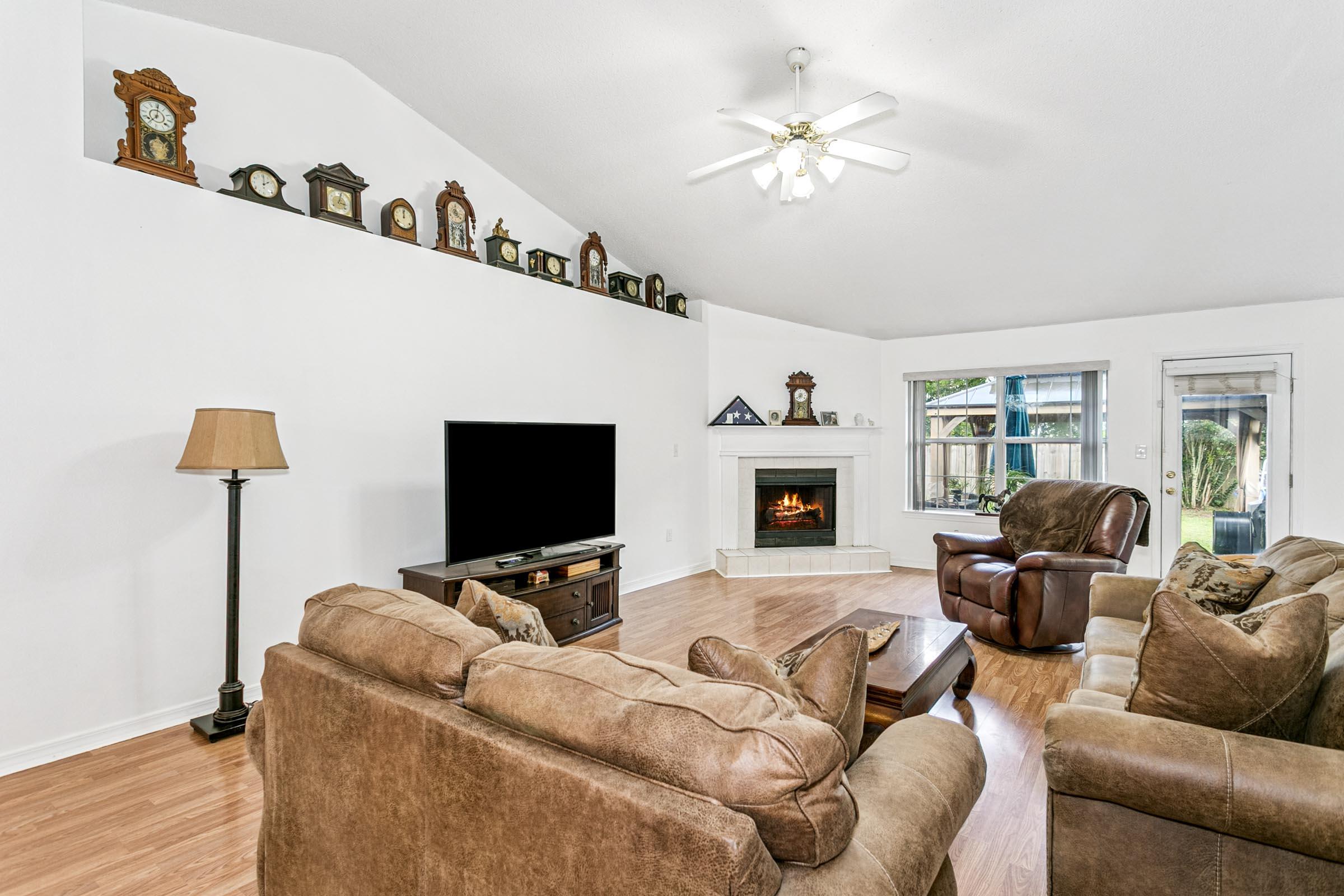 2246 Titanium Drive Crestview, FL 32536 - Photo 6 of 38 a living room with furniture a flat screen tv and a fireplace