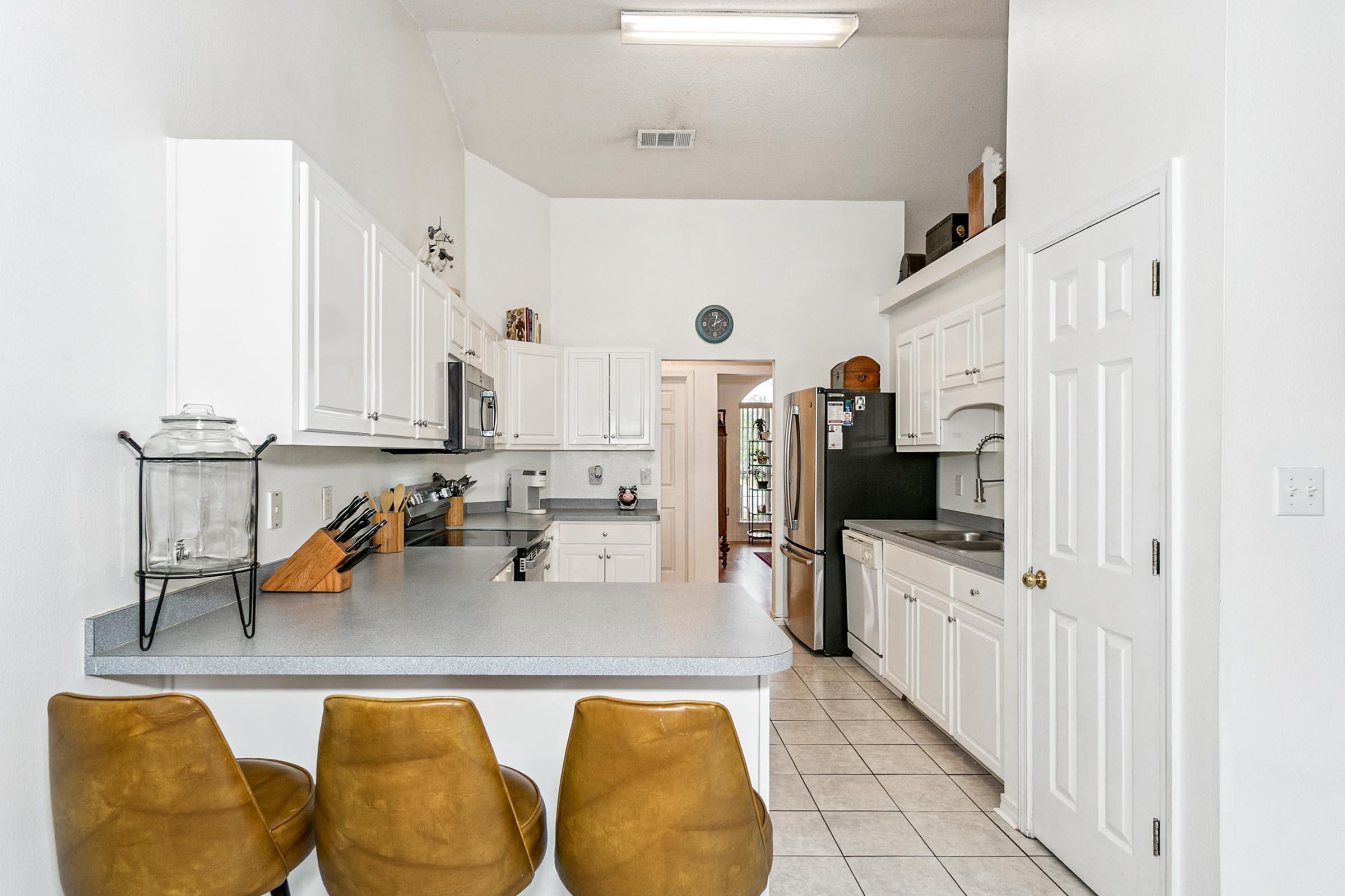 2246 Titanium Drive Crestview, FL 32536 - Photo 7 of 38 a kitchen with stainless steel appliances granite countertop a sink and a refrigerator