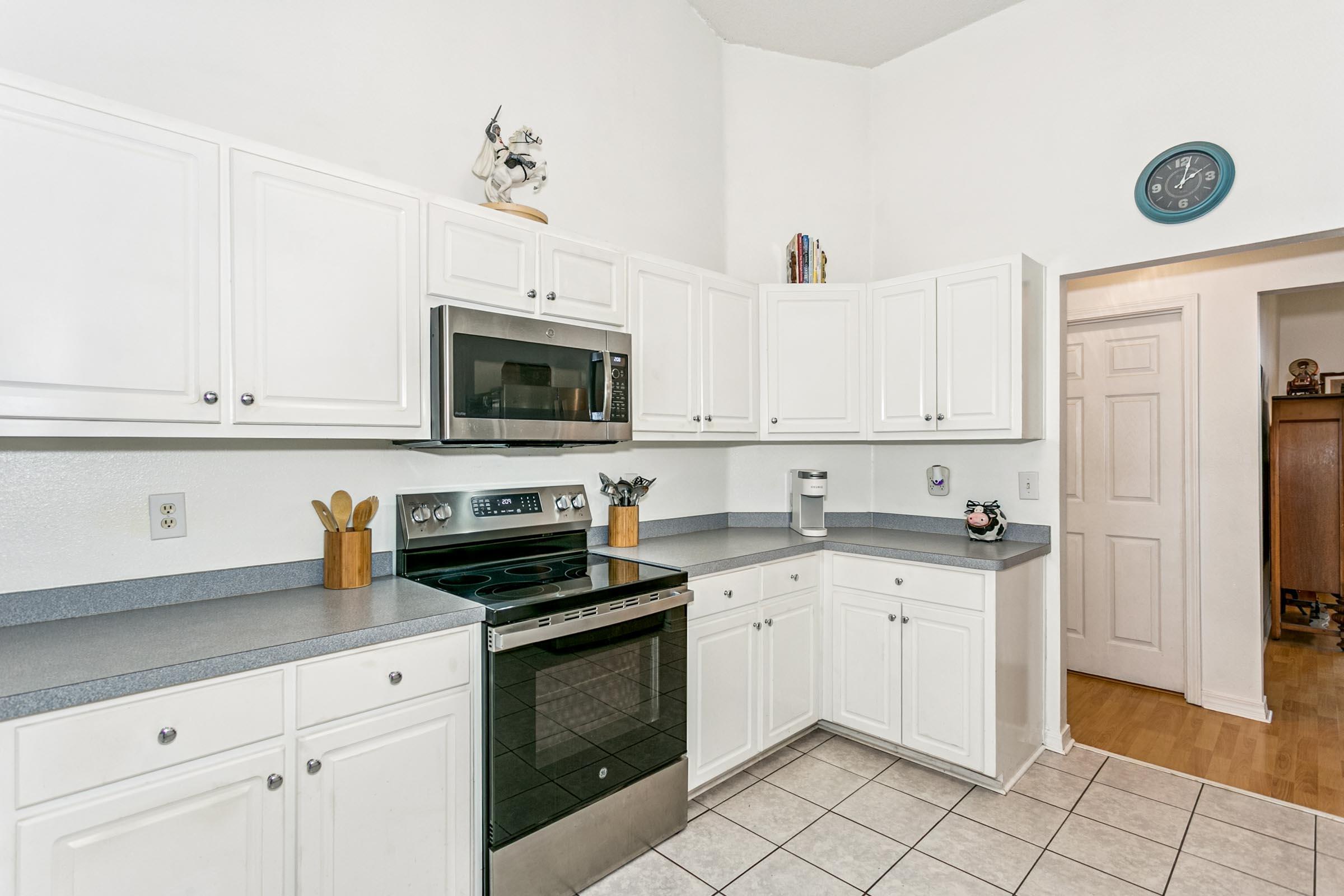 2246 Titanium Drive Crestview, FL 32536 - Photo 8 of 38 a kitchen with granite countertop a sink stainless steel appliances and white cabinets