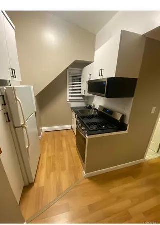 a kitchen with granite countertop a stove and a refrigerator