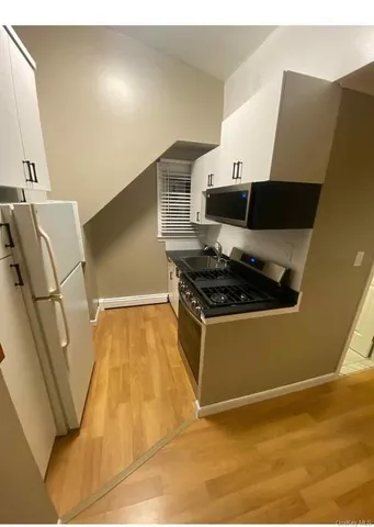 a kitchen with granite countertop a stove and a refrigerator