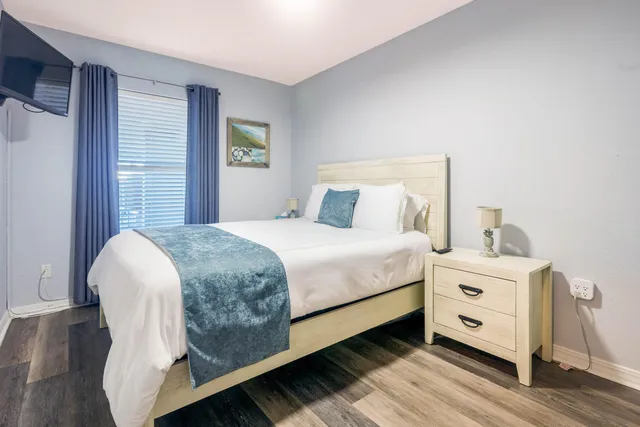 a bed room with a bed and a tv