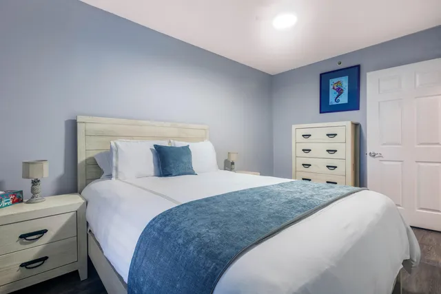 a bedroom with a bed and a dresser