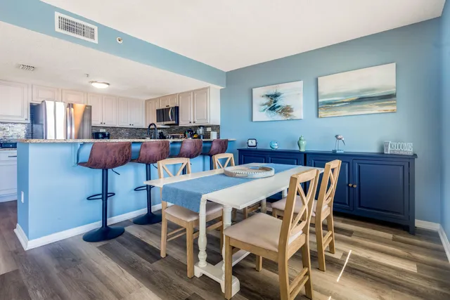 a view of a dining room with furniture and wooden floor