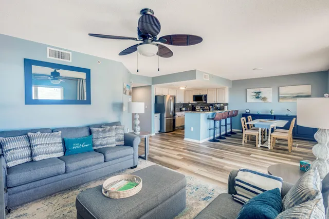 a living room with furniture and kitchen view
