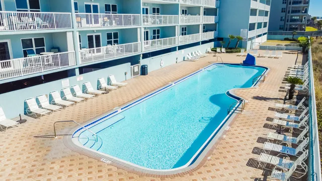 a view of a swimming pool with outdoor seating